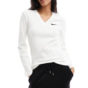 Nike women’s ribbed long-sleeve shirt in an off-white or cream color.